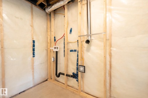 Unfinished interior space featuring wood framing, insulation, and exposed electrical and plumbing rough-ins - 5403 Lark Landing Nw, Edmonton, AB - Indoor Photo Showing Basement