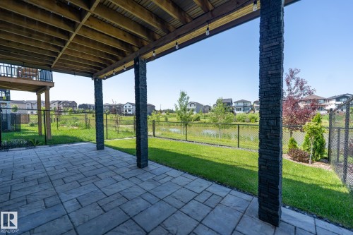Covered patio with stone-clad columns and a paver surface - 5403 Lark Landing Nw, Edmonton, AB - Outdoor