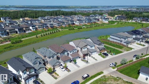 Residential streetscape showcasing contemporary homes with varied exterior finishes and attached garages - 5403 Lark Landing Nw, Edmonton, AB -  With View