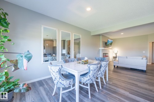 Spacious dining area featuring wood-finish flooring and recessed lighting - 5403 Lark Landing Nw, Edmonton, AB - Indoor Photo Showing Dining Room