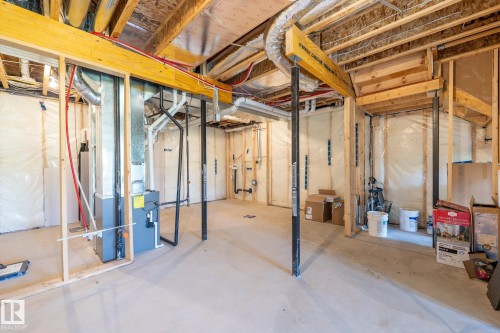 Unfinished basement with concrete flooring, exposed wood framing, and visible ductwork - 5403 Lark Landing Nw, Edmonton, AB - Indoor Photo Showing Basement