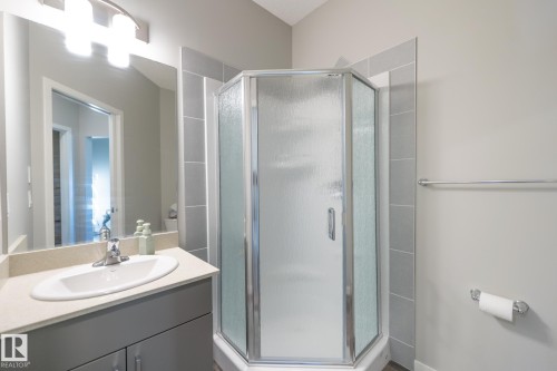 Corner shower with frosted glass enclosure and chrome hardware - 5403 Lark Landing Nw, Edmonton, AB - Indoor Photo Showing Bathroom