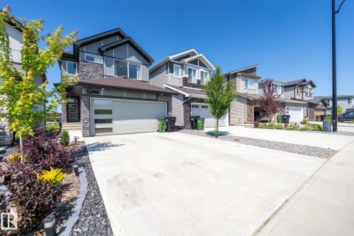 Contemporary home exterior featuring a multi-tone facade with stone accents and horizontal siding - 5403 Lark Landing Nw, Edmonton, AB - Outdoor With Facade