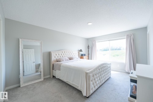 Spacious bedroom with light gray walls and recessed ceiling lighting - 5403 Lark Landing Nw, Edmonton, AB - Indoor Photo Showing Bedroom