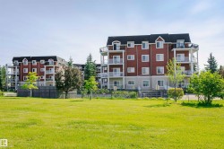 Multi-story residential buildings with red siding and white trim - 