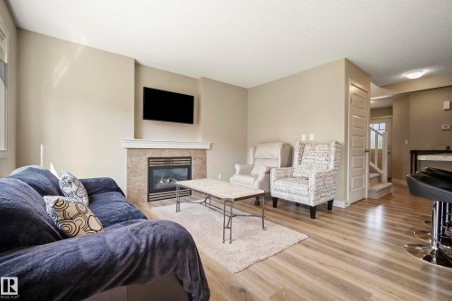 1715 Cunningham Way Sw, Edmonton, AB - Indoor Photo Showing Living Room With Fireplace