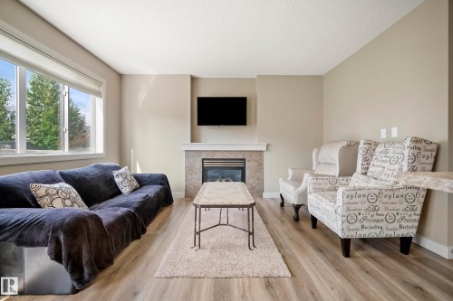 1715 Cunningham Way Sw, Edmonton, AB - Indoor Photo Showing Living Room With Fireplace