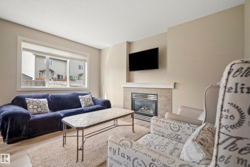 1715 Cunningham Way Sw, Edmonton, AB - Indoor Photo Showing Living Room With Fireplace