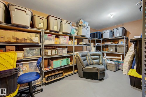 Dedicated storage room featuring extensive metal shelving systems and durable flooring - 38 Longview Point(E), Spruce Grove, AB - Indoor