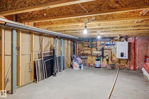 Unfinished basement with exposed ceiling joists, concrete flooring, and visible plumbing and electrical infrastructure - 38 Longview Point(E), Spruce Grove, AB - Indoor Photo Showing Basement