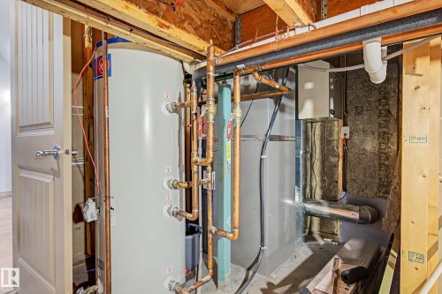 Utility area featuring a water heater, copper piping, and HVAC system - 38 Longview Point(E), Spruce Grove, AB - Indoor Photo Showing Basement