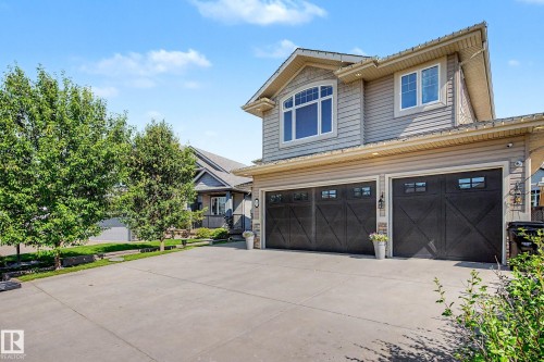 Two-story residence featuring light gray siding with white trim accents and a two-car garage - 38 Longview Point(E), Spruce Grove, AB - Outdoor