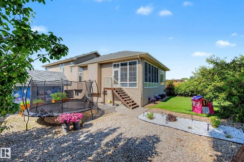 Rear exterior with a screened-in porch and exterior staircase - 38 Longview Point(E), Spruce Grove, AB - Outdoor With Deck Patio Veranda
