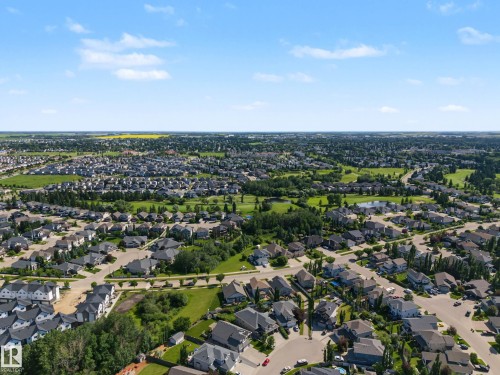 Expansive residential area featuring numerous single-family homes with diverse architectural styles, mature trees, and abundant green spaces - 38 Longview Point(E), Spruce Grove, AB - Outdoor With View