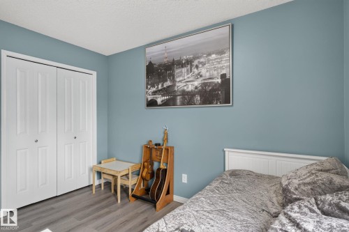 Room featuring wood-finish flooring and a closet with bi-fold doors - 833 Mcallister Crescent Sw, Edmonton, AB - Indoor Photo Showing Bedroom