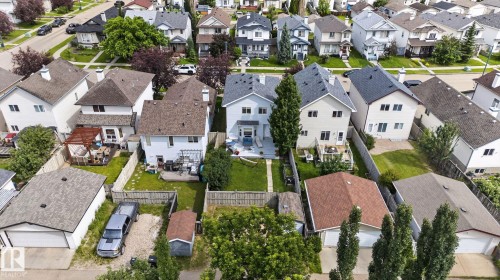 Detached property featuring an expansive fenced backyard with a wood-stained gazebo, mature landscaping, and a wood-decked patio - 833 Mcallister Crescent Sw, Edmonton, AB - Outdoor