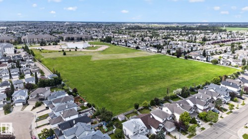 Expansive green space surrounded by established residential areas and commercial structures - 833 Mcallister Crescent Sw, Edmonton, AB - Outdoor With View