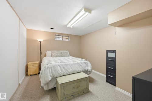Carpeted room with neutral wall tones and white baseboards - 15111 67 Street Nw, Edmonton, AB - Indoor Photo Showing Bedroom