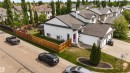 Contemporary white exterior with a contrasting dark roof, featuring a vibrant pink front door - 679 Kananaskis Drive, Devon, AB  - Outdoor 