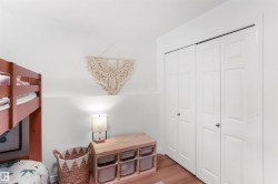 White bi-fold closet doors with silver-tone hardware - 