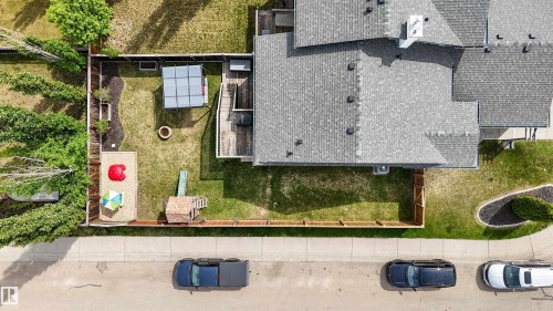 Expansive rear yard featuring a large deck, fenced perimeter, and a gravel play area - 679 Kananaskis Drive, Devon, AB - Outdoor