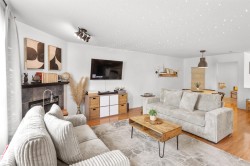 Open-concept living space featuring wood-finish flooring and recessed lighting - 