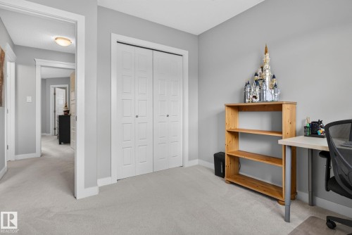 Interior room featuring light gray walls, white trim, and light-toned carpeting - 319 Desrochers Boulevard Sw, Edmonton, AB - Indoor Photo Showing Other Room