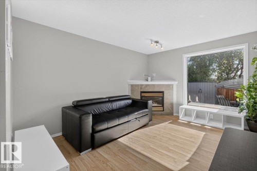Living room - #18 345 Kirkness Rd Nw, Edmonton, AB - Indoor Photo Showing Living Room With Fireplace
