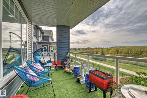 Covered balcony with artificial turf flooring - 4104 8 Street Nw, Edmonton, AB - Outdoor With Exterior
