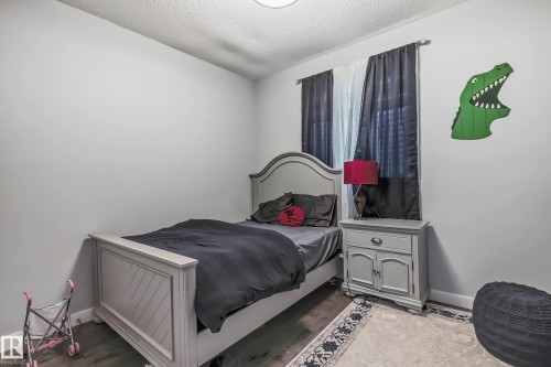 Light gray walls with textured ceiling - 4104 8 Street Nw, Edmonton, AB - Indoor Photo Showing Bedroom
