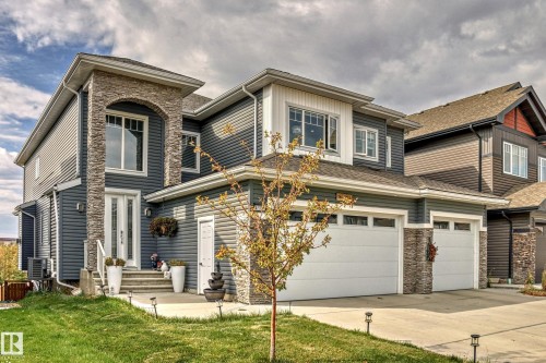 Contemporary exterior featuring dark siding and stone veneer accents - 4104 8 Street Nw, Edmonton, AB - Outdoor With Facade