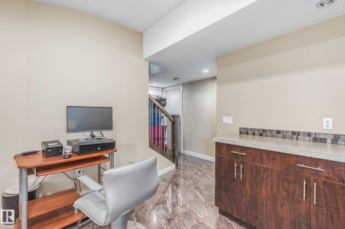 Accent wall featuring built-in cabinetry with a light-toned countertop and mosaic tile backsplash - 4104 8 Street Nw, Edmonton, AB - Indoor