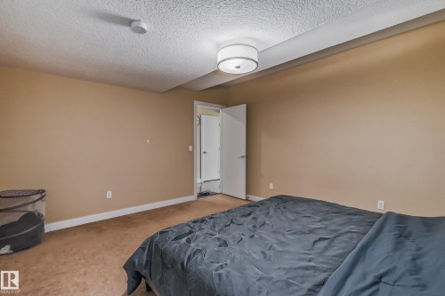 Carpeted room with neutral wall tones and a white ceiling - 4104 8 Street Nw, Edmonton, AB - Indoor Photo Showing Bedroom
