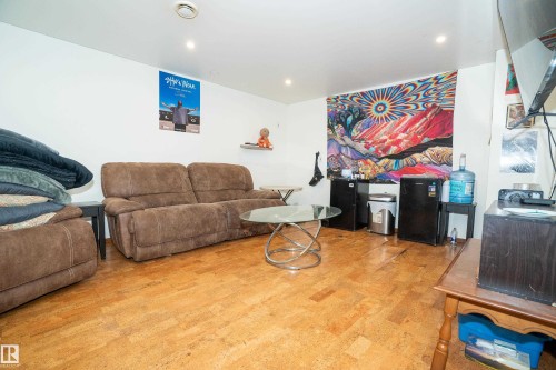 Recessed lighting illuminates an open space featuring light wood-finish flooring - 5307 105 Street Nw, Edmonton, AB - Indoor Photo Showing Living Room