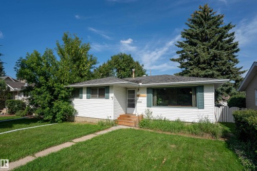 White siding exterior with a dark shingle roof and a front lawn - 5307 105 Street Nw, Edmonton, AB - Outdoor