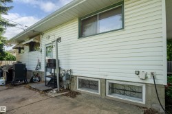 White vinyl siding exterior with an awning-covered entry door - 