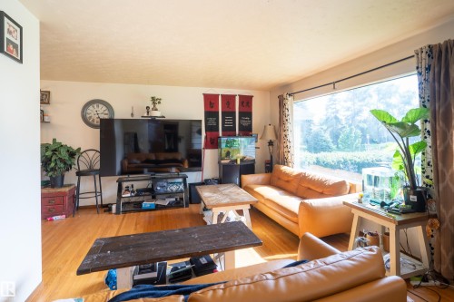 Hardwood flooring complementing light-toned wall finishes - 5307 105 Street Nw, Edmonton, AB - Indoor Photo Showing Living Room