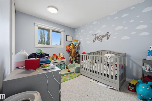 Light blue walls with a cloud motif - 4810 55 Avenue, Beaumont, AB - Indoor Photo Showing Bedroom