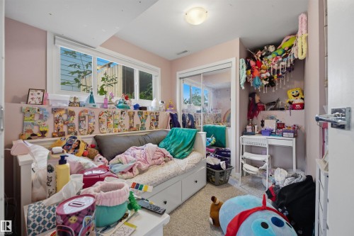Bedroom featuring dual windows, ceiling-mounted light fixture, and carpet flooring - 4810 55 Avenue, Beaumont, AB - Indoor