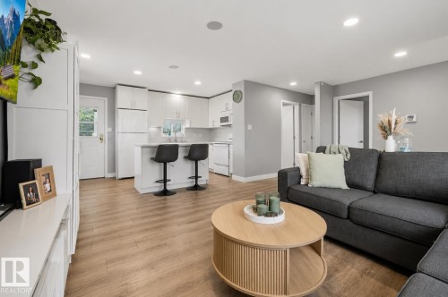 Open-concept living space featuring wood-finish flooring, recessed lighting, and a neutral wall palette - 4810 55 Avenue, Beaumont, AB - Indoor Photo Showing Living Room