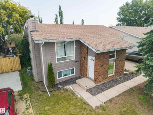 Split-level residence featuring a brick facade and horizontal siding - 4810 55 Avenue, Beaumont, AB - Outdoor