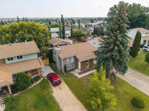 Split-level residence featuring a brown shingle roof and a light brown exterior - 4810 55 Avenue, Beaumont, AB - Outdoor