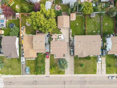 Aerial view showcasing multiple properties with shingled roofs and private backyards - 4810 55 Avenue, Beaumont, AB - Outdoor With View