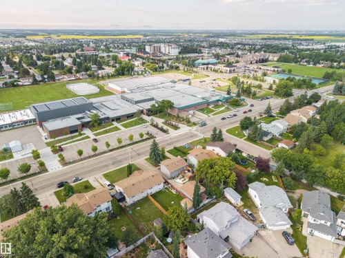 Aerial perspective showcasing a residential neighborhood with a prominent educational facility - 4810 55 Avenue, Beaumont, AB - Outdoor With View