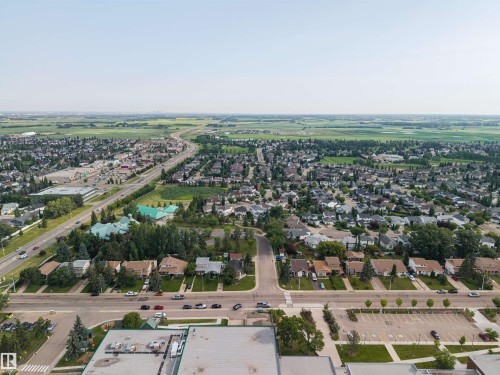 Aerial perspective showcasing an expansive suburban residential area - 4810 55 Avenue, Beaumont, AB - Outdoor With View