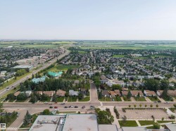 Aerial perspective showcasing an expansive suburban residential area - 