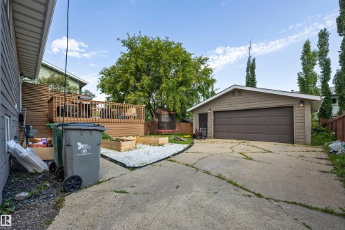 Detached garage featuring a horizontal panel garage door and exterior lighting - 4810 55 Avenue, Beaumont, AB - Outdoor With Exterior