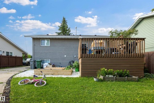Elevated wooden deck structure with vertical railings - 4810 55 Avenue, Beaumont, AB - Outdoor With Exterior
