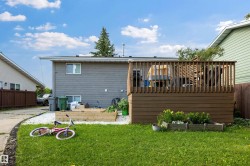 Elevated wooden deck structure with vertical railings - 