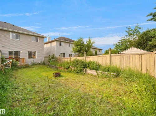 Expansive backyard featuring a partial grass area, wood privacy fencing, and a storage shed - 8111 7 Avenue Sw, Edmonton, AB - Outdoor